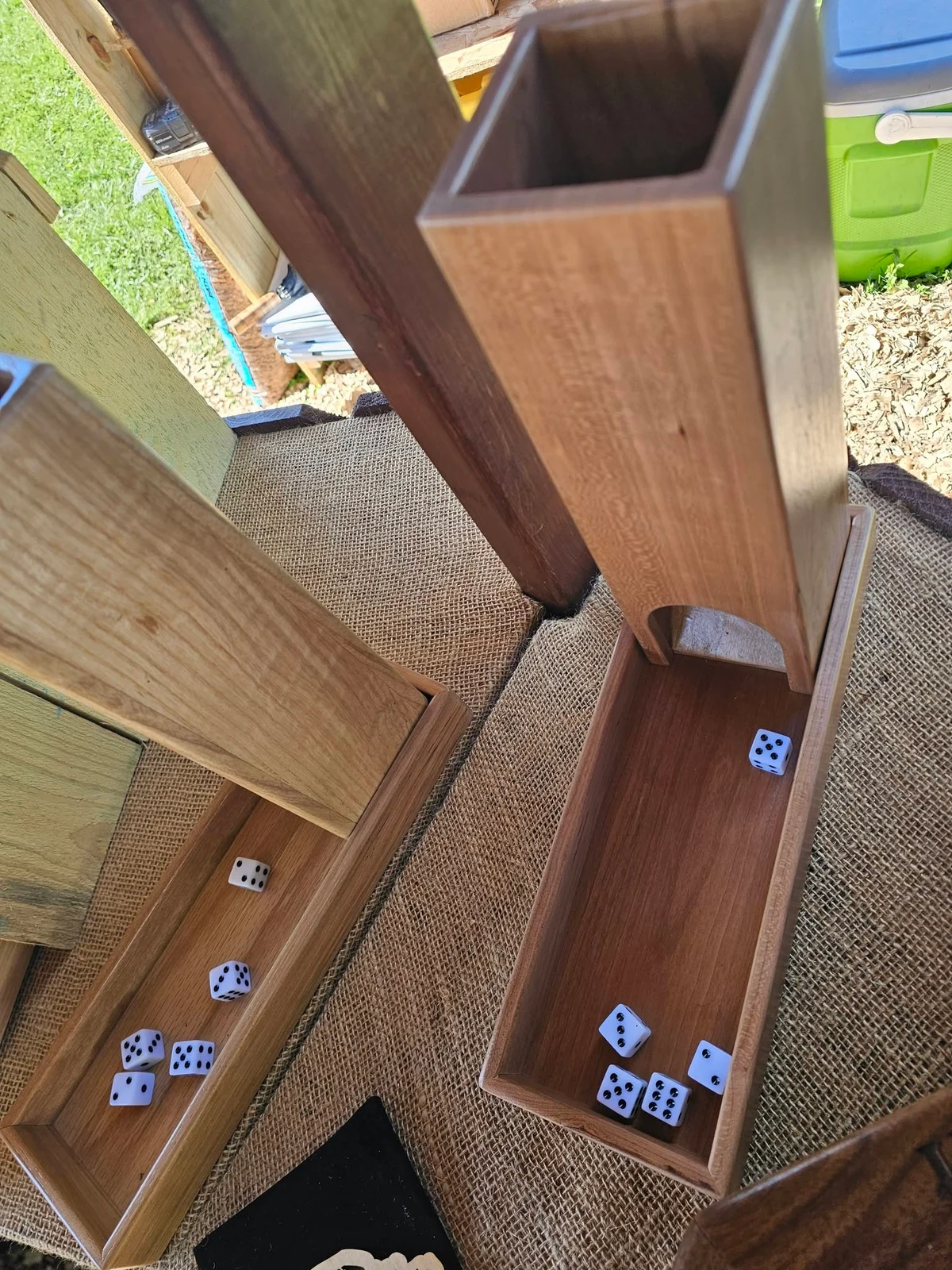 Wooden dice towers and their long dice-catching trays.