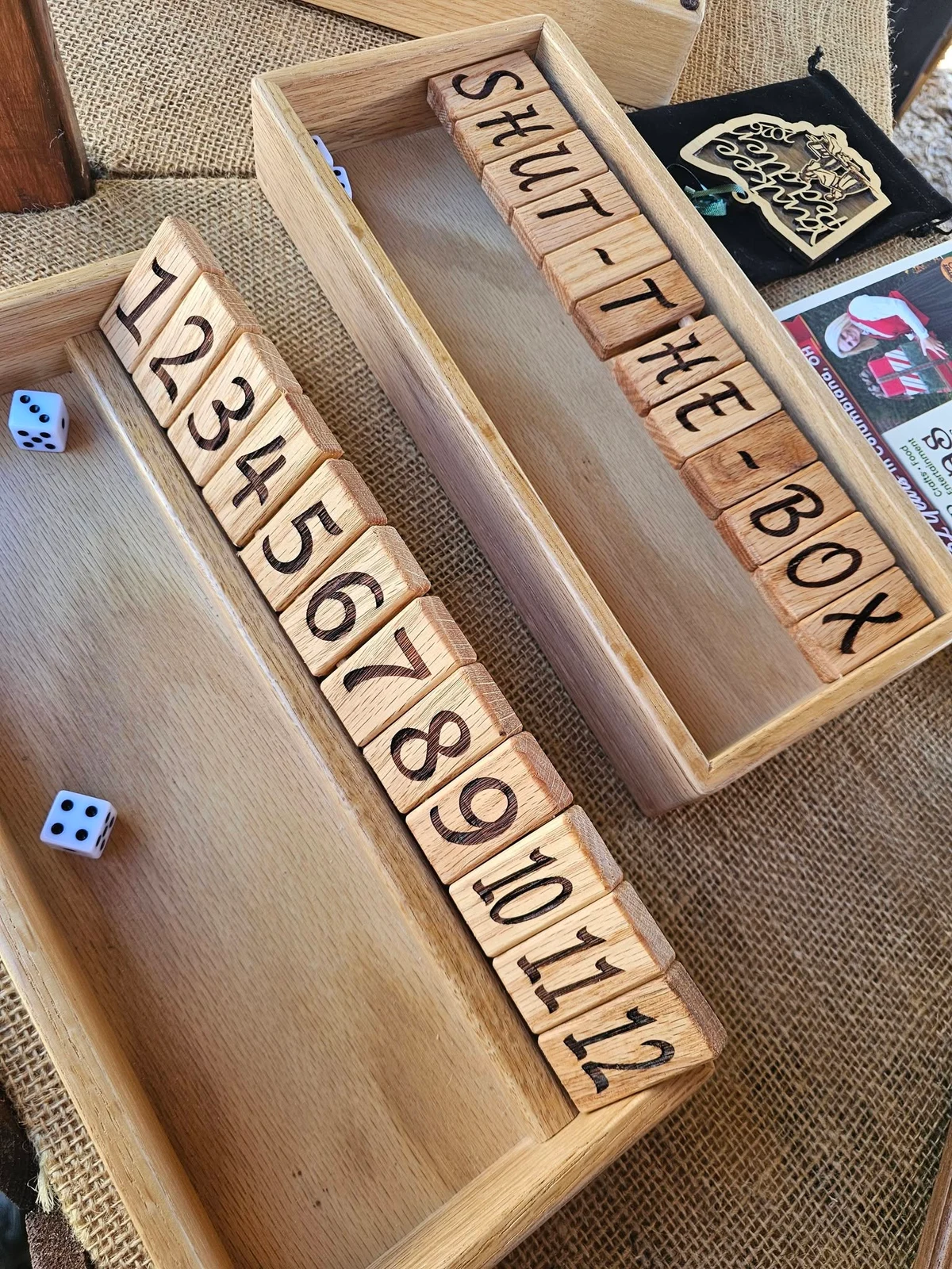 Wooden Shut the Box games with numbered hinged tiles and dice.