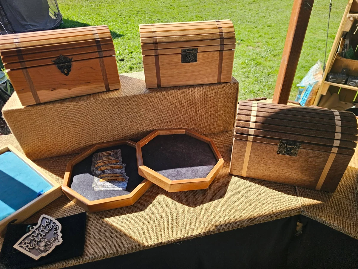 Wooden keepsake chests and open octagonal trays on a display table.