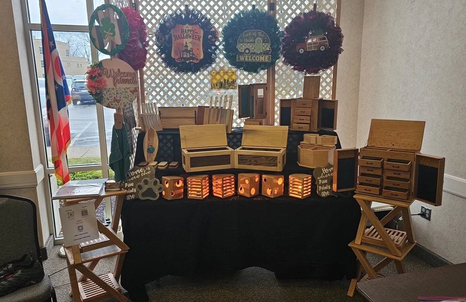 Red’s Facebook cover photo: a display of wooden boxes, cabinets and illuminated wooden nightlights.
